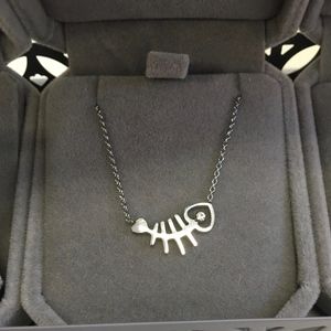 Silver/white gold tone  fish pendant necklace. New